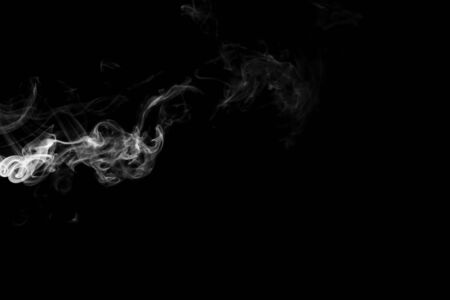 White smoke isolated on black backgroundの写真素材