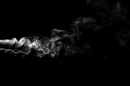 White smoke isolated on black backgroundの写真素材