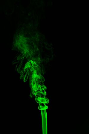Green coloured smoke abstract lighting on a black backgroundの写真素材