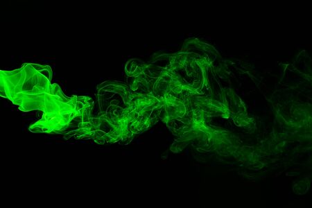 Green coloured smoke abstract lighting on a black backgroundの写真素材