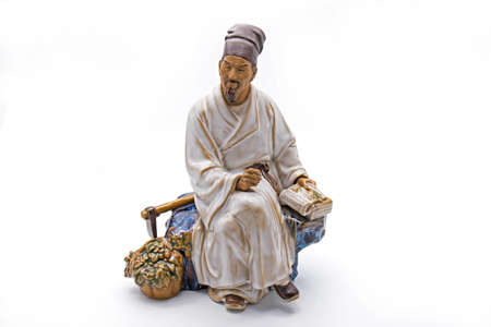 Chinese Old Man Sit and Thoughtful Statue Isolated on White Backgroundの写真素材