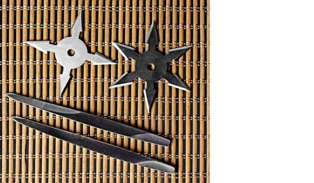 Closeup Ninja Star Shurikens with throwing spikes on Wooden Background, Copy Spaceの写真素材