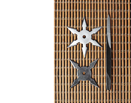 Closeup Ninja Star Shurikens with throwing spikes on Wooden Background, Copy Spaceの写真素材