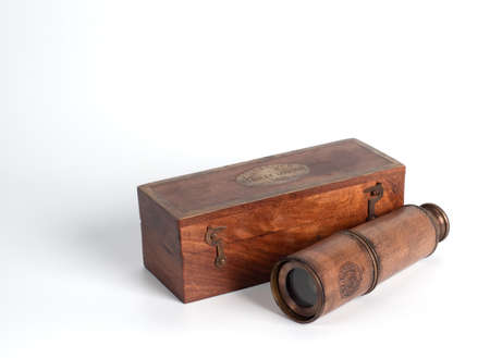 Bangkok, Thailand - June 02, 2019 : Closeup antique monocular telescope with wooden box isolated on white background, Illustrative Editorial.のeditorial素材