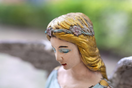 Close-up of antique angel statues isolated on blurry background.の写真素材