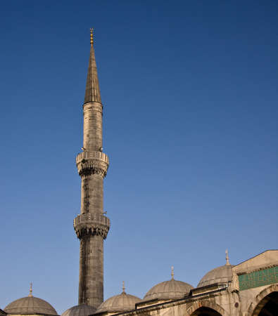 Minaret on the Blue Mosque in Istanbul against a bright blue skyの写真素材