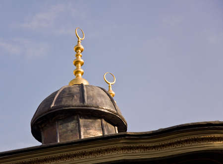 Detail of the golden spires and circular shapes on the roof of building in Istanbulの写真素材