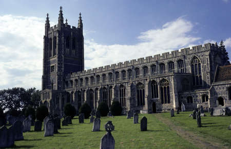 Cathedral like ancient english church and graveyard on sunny day