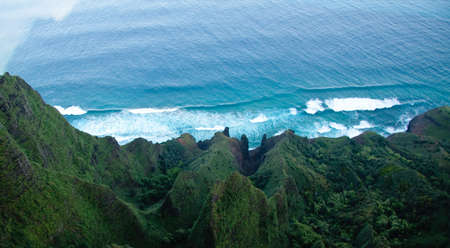 Aerial view down the cliffs of Na Pali coast to the oceanの写真素材