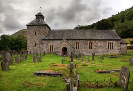 Threatening skies over the old stone church of Melangellの写真素材