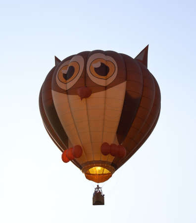 Hot air ballon in the air with the shape of an owl with eyes and earsの写真素材
