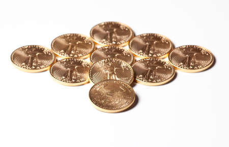 Solid gold eagle coins in the shape of a diamondの写真素材