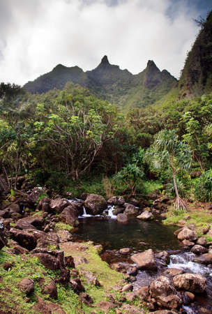 Rippling river flows from high peaks of Na Pali range on Kauaiの写真素材