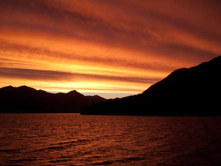 Brilliant sunset over the sea near Queenstown in New Zealandの写真素材