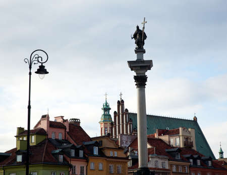 View towards the old town of Warsaw in Poland showing the multi colored houses and churchesの写真素材