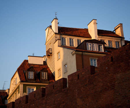 View towards the old town of Warsaw in Poland showing the multi colored houses and churchesの写真素材