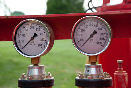 Two similar pressure gauges on heavy equipmentの写真素材