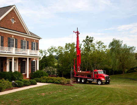 Drilling for geothermal power system in suburban yard Drilling for geothermal power system in suburban yard