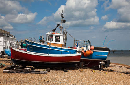 Fishing boats beached on stony beach of Deal on Kent coast of Englandの写真素材