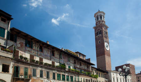 Old painted buildings in Erbe square in Verona with Lamberti Towerの写真素材