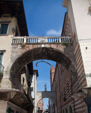 Arches between Erbe and Signori in Verona with hanging whale boneの写真素材