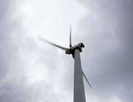 Wind turbine in wind farm on cloudy day in North Walesの写真素材