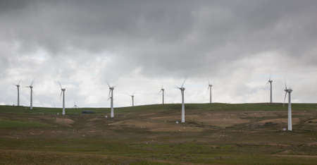 Wind turbines in wind farm on cloudy day in North Wales