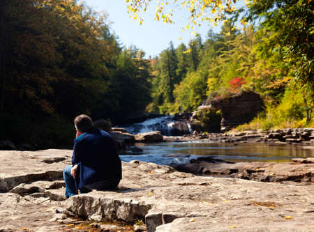 Lady watching the upper falls in Swallow Falls State Park in Maryland USAの写真素材