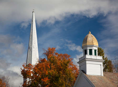 Autumnal shot of the main street of Manchester Vermont in fall as the bright trees turn orange and redの写真素材