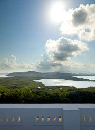 View across a lagoon towards El Yunque across with the distant rain falling on the rain forestの写真素材