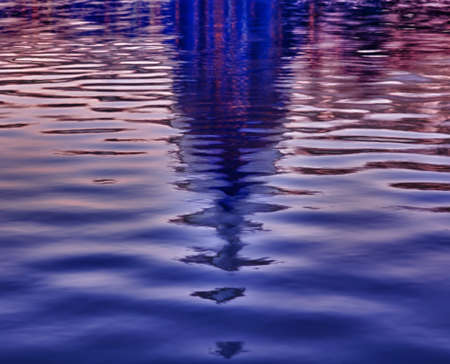Brightly lit dawn sky behind the illuminated dome of the Capitol in Washington DC reflecting in the...