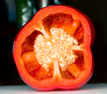 Interior of sliced red pepper in macro shot showing seeds and details of the inside of the vegetable