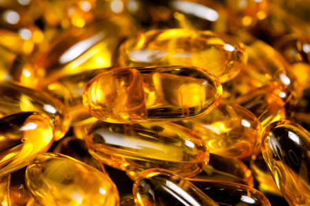 Macro image of a pile of fish oil or omega3 capsules for healthの写真素材