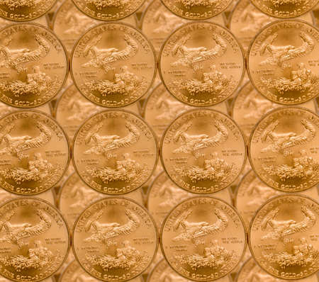Gold Eagle one ounce coins in a patterns and stacked on each rowの写真素材