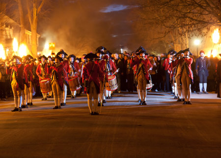 WILLIAMSBURG, VIRGINIA - DECEMBER 29: Marching soldiers at night on December 29, 2011. Colonial Williamsburg's 301 acres includes many restored buildings and houses and hosts re-enactments.のeditorial素材