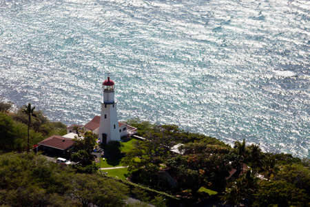 Lighthouse on coast under the summit of the old volcano of Diamond Headの写真素材
