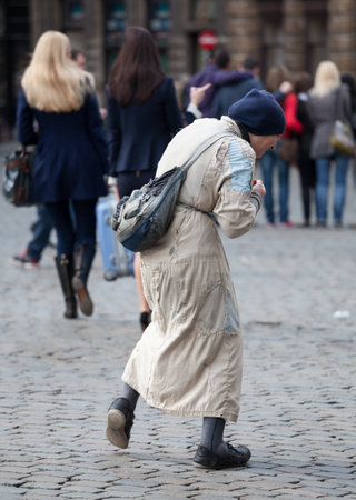 BRUSSELS, BELGIUM - MARCH 19: Old woman begging in Grand Place in Brussels on March 19, 2012. Belgium debt approaches 100% of GDP and crisis is putting more people on streetsのeditorial素材