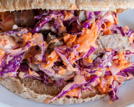 Chopped red cabbage, carrots and onions as coleslaw with beef in pita breadの写真素材