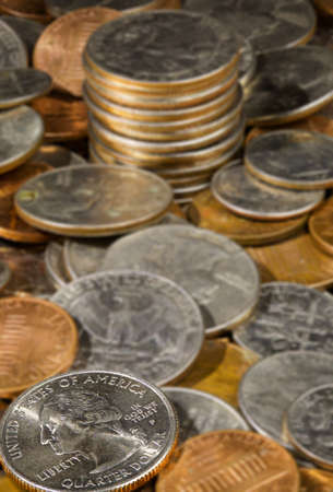 Macro image withy focus on quarter in a pile of USA currency coins in stacks