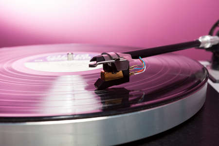 Long Playing record LP on retro record player with tone arm and cartridge