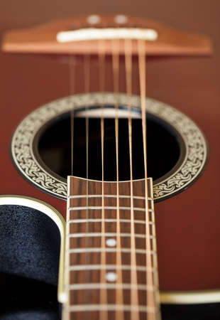 Macro shot down the fretboard of acoustic guitar with shallow depth of fieldの写真素材