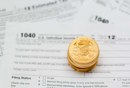 Tax form 1040 for tax year 2012 for US individual tax return with gold coins