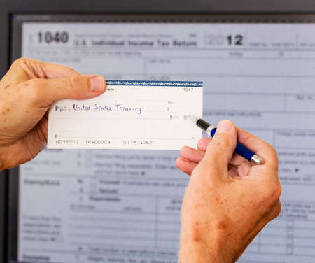Electronic tax form 1040 for 2012 for US individual return on screen with check payable to US Treasuryの写真素材