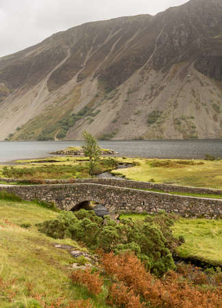 Ancient stone bridge over river running into Wastwater in Lake Districtの写真素材