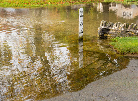 Depth gauge at deep river at road ford on Shill Brook at Shilton Oxfordshireの写真素材