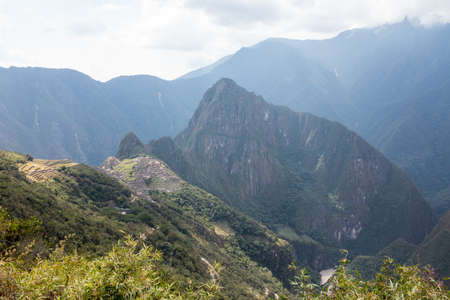 Morning views of Machu Picchu as mist clears from the mountainsideの写真素材