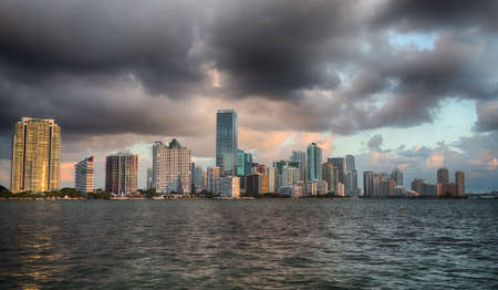 Miami cityscape skyline at dawn sunrise from Rickenbacker causeway on cloudy morningの写真素材