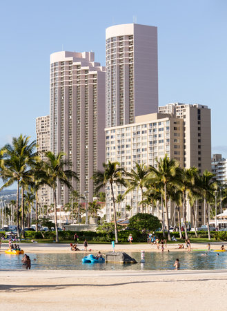 WAIKIKI, HI - JANUARY 20: Tourists sunbathe on busy Hawaii beach on 20 January 2012. The Waikiki Beach restoration project was completed early 2012.のeditorial素材