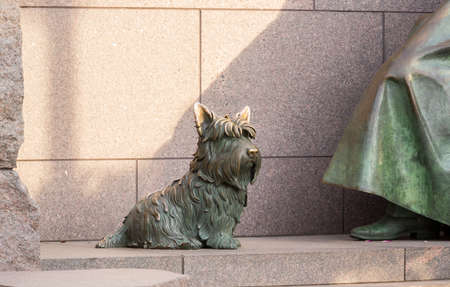 Detail of pet dog by statue in memorial monument to President Franklin Delano Roosevelt in Washington DCの写真素材