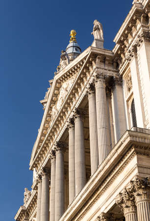 Perspective view of the west front of St Pauls Cathedral in London England at dusk as the sun is...